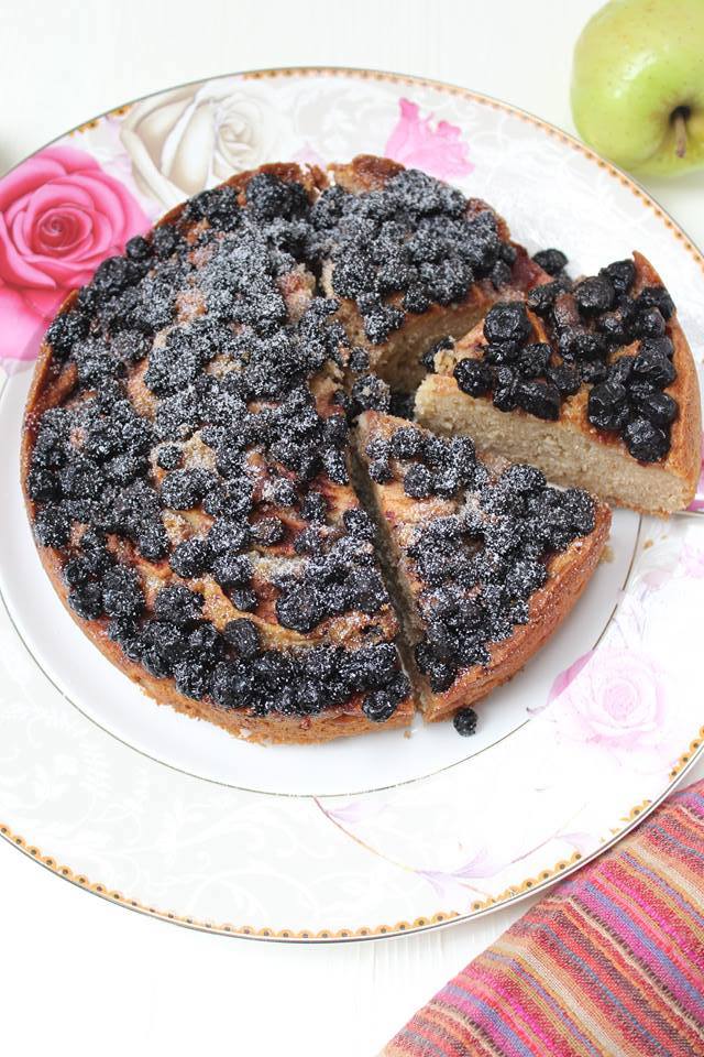 Fall tea time cake topped with apple wedges and blackberries